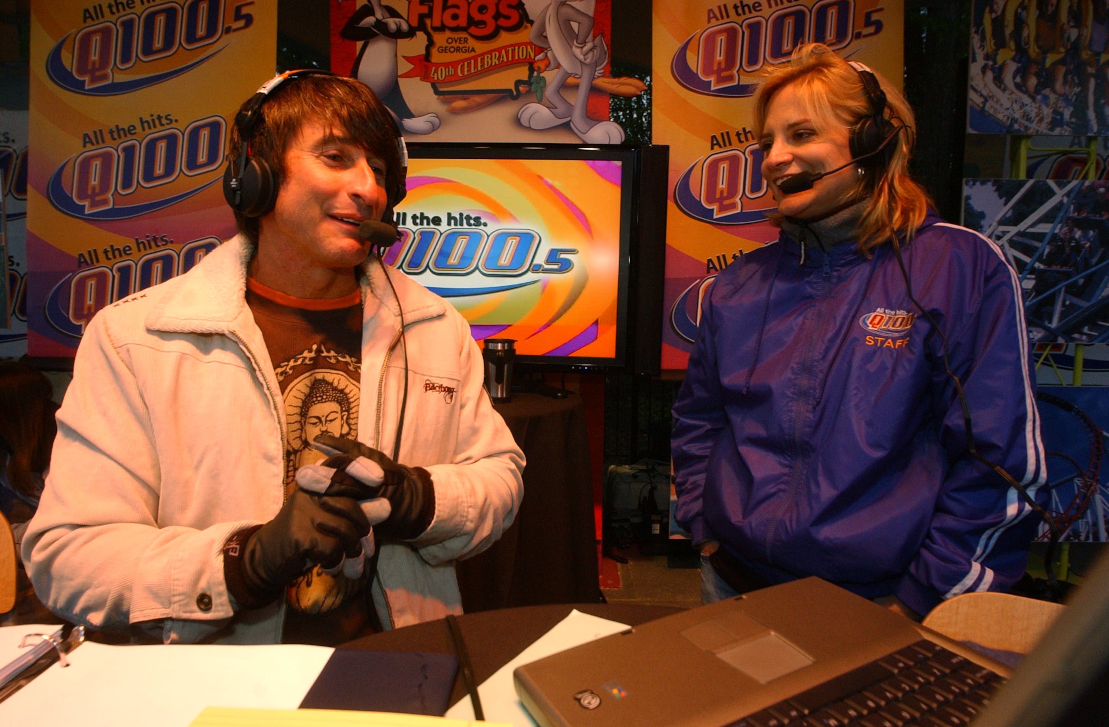 Bert Weiss, left, of the Q100 radio Bert Show and Melissa Carter, right, also of the Bert Show, host the radio show from Six Flags Over Georgia Thursday, April 5, 2007. The park was open for free for the radio station promotion that drew thousands more people than were expected, causing snarled traffic and many people who were turned away when the park reached its capacity at 5:50 am and no more people were allowed in. Some people arrived as early as 2 am to get in free. (Kimberly Smith / AJC staff)