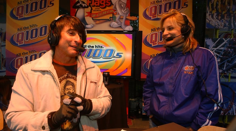 070405 - ATLANTA, GA -- Bert Weiss), left, of the Q100 radio Bert Show and Melissa Carter, right, also of the Bert Show, host the radio show from Six Flags Over Georgia Thursday, April 5, 2007. The park was open for free for the radio station promotion that drew thousands more people than were expected, causing snarled traffic and many people who were turned away when the park reached its capacity at 5:50 am and no more people were allowed in. Some people arrived as early as 2 am to get in free. (Kimberly Smith / AJC staff)