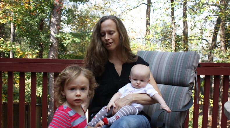 DeKalb County resident Jennifer Fair brought two of her three daughters with her to vote Thursday at an early voting location in Decatur. She was asked to leave when 2-year-old Casey, left, would not stop crying. Fair said the state law on children in polling locations is not family friendly. CHRIS JOYNER / CJOYNER@AJC.COM