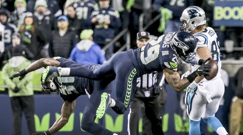 Seattle Seahawks safety Kam Chancellor, left, and Seahawks safety Earl Thomas collide on a pass during the first half of an NFL football game against the Carolina Panthers, Sunday, Dec. 4, 2016, in Seattle. (Kevin Clark/The Herald via AP)