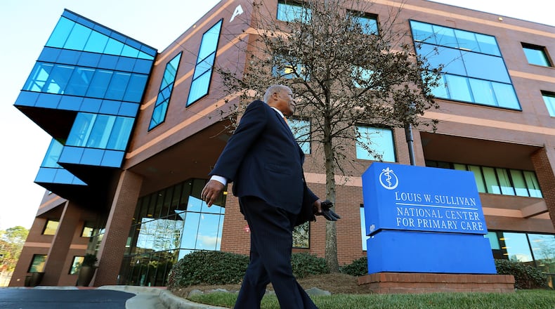 Dr. Louis W. Sullivan, the founding dean and first president of Morehouse School of Medicine, walks past the building bearing his name, the Louis W. Sullivan National Center for Primary Care.