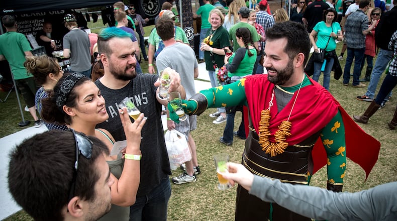 Vince Daris (in the costume) toasts with friends at the Suwanee Beer Fest in 2016. This year’s fest takes place on Saturday, March 16. STEVE SCHAEFER / SPECIAL TO THE AJC