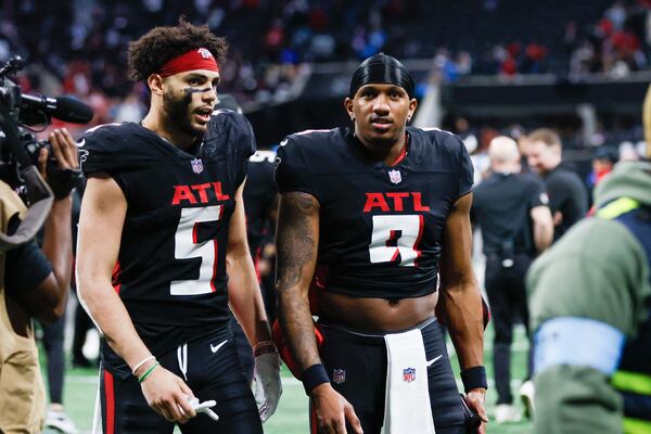 Falcons quarterback Michael Penix Jr. (right) and wide receiver Drake London (left) converse after their season-ending loss to Carolina.