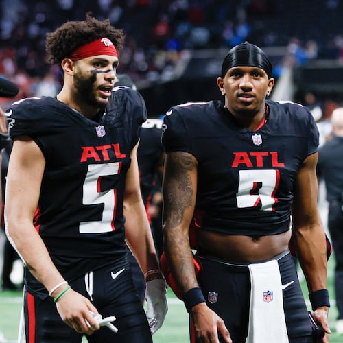 Atlanta Falcons quarterback Michael Penix Jr. (9) and wide receiver Drake London (5) converse as they leave the field following the Falcons’ overtime loss to the Carolina Panthers January 5, 2025, at Mercedes-Benz Stadium in Atlanta. 
(Miguel Martinez/ AJC)