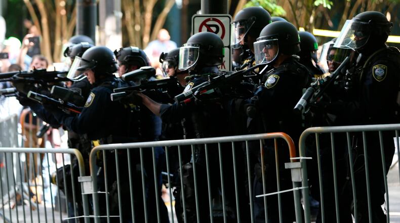 Police disperse clashing protesters as problems occurred when two opposing groups took to the streets in Portland, Oregon, on Saturday.