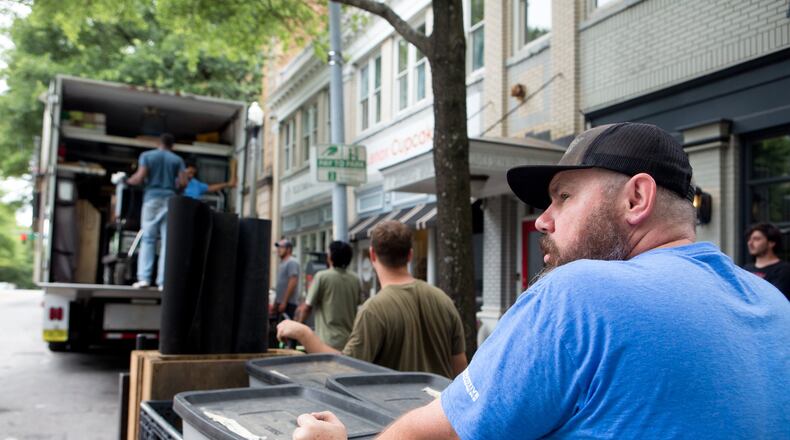 Workers pack up gear on the set of HBO’s “Brooklyn” project in downtown Decatur in 2019. (Casey Sykes for The Atlanta Journal-Constitution)
