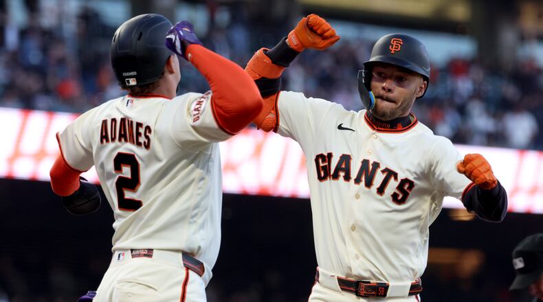 San Francisco Giants' Grant McCray, right, celebrates with Willy Adames (2) after hitting a two-run home run during the fourth inning of a baseball game against the Milwaukee Brewers in San Francisco, Monday, July 27, 2026. (AP Photo/Jed Jacobsohn)
