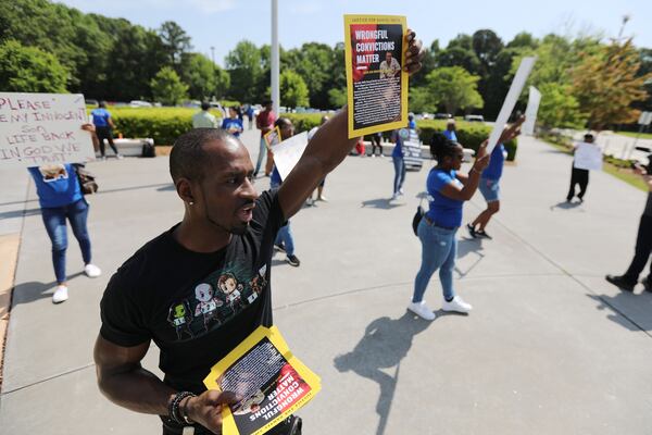 Family and friends gather outside of the Gwinnett Justice and Administration Center in 2022 in support of Danyel Smith, who in 2003 was convicted of shaking his baby to death. A request for a new trial is pending before the Georgia Supreme Court.  (Miguel Martinez/AJC/TNS)