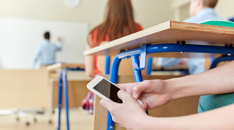 Schools have realized they’ve lost the battle for student attention to the ubiquitous smartphone. Yet many hesitate to ban the phones outright. (Dreamstime/TNS)