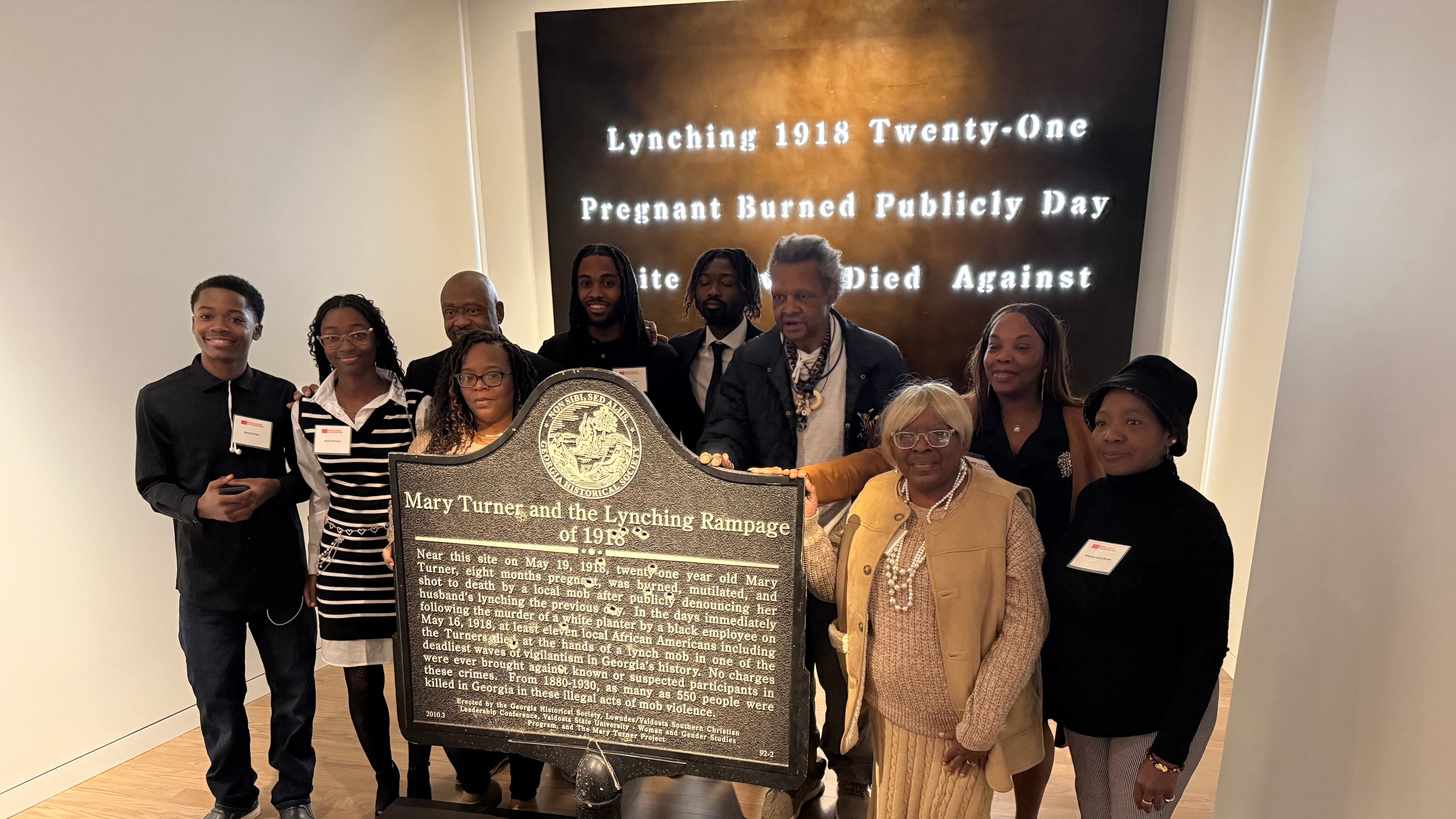 Descendants of Mary Turner, who was lynched in 1918, pose with her historic marker and artist Lonnie Holley, fourth from left, at the National Center for Civil and Human Rights, on Dec. 6, 2025 in Atlanta. (AP Photo/Michael Warren)