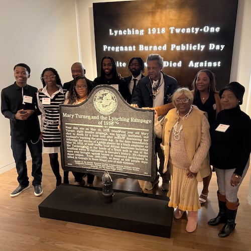 Descendants of Mary Turner, who was lynched in 1918, pose with her historic marker and artist Lonnie Holley, fourth from left, at the National Center for Civil and Human Rights, on Dec. 6, 2025 in Atlanta. (AP Photo/Michael Warren)