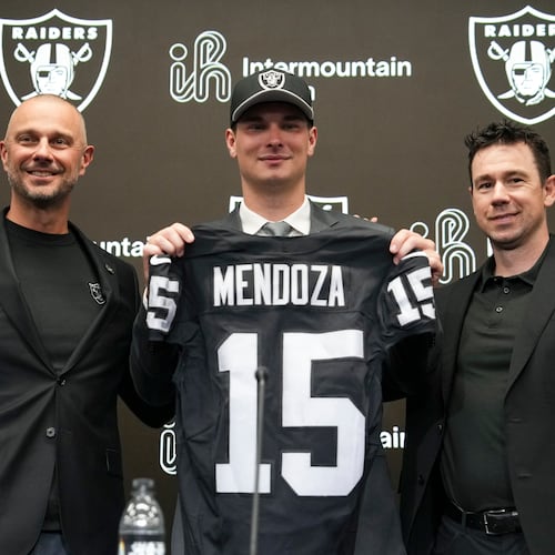 From left to right, Las Vegas Raiders general manager John Spytek, first-round draft pick Fernando Mendoza and head coach Klint Kubiak pose for a photo during an NFL football news conference Friday, April 24, 2026, in Henderson, Nev. (AP Photo/Candice Ward)