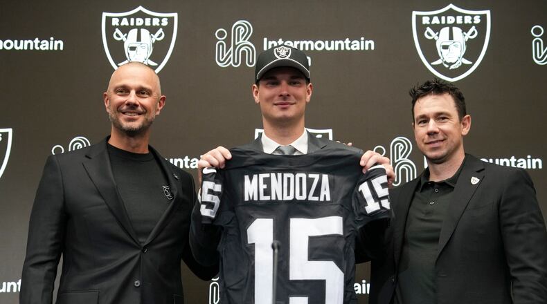 From left to right, Las Vegas Raiders general manager John Spytek, first-round draft pick Fernando Mendoza and head coach Klint Kubiak pose for a photo during an NFL football news conference Friday, April 24, 2026, in Henderson, Nev. (AP Photo/Candice Ward)