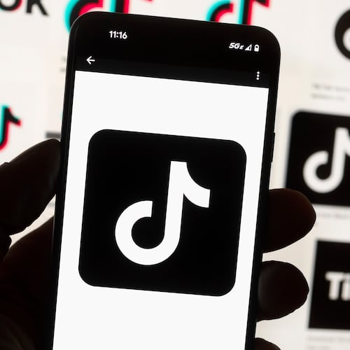 FILE - The TikTok logo is displayed on a mobile phone in front of a computer screen, Oct. 14, 2022, in Boston. (AP Photo/Michael Dwyer, File)