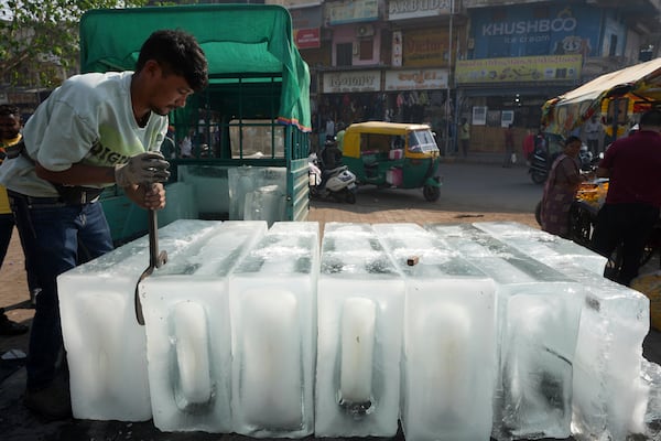 A man arranges ice blocks to sell at his stall in Ahmedabad, India, Wednesday, April 2, 2025. (AP Photo/Ajit Solanki)