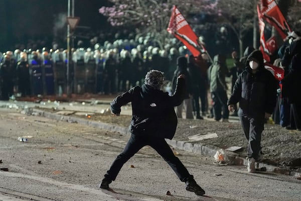 Protesters clash with riot police during a protest against the arrest of Istanbul's Mayor Ekrem Imamoglu, in Istanbul, Turkey, Saturday, March 22, 2025. (AP Photo/Khalil Hamra)