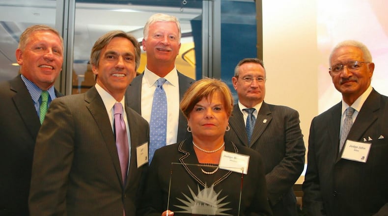 Current and former members of the Judicial Qualifications Commission accept the Georgia First Amendment Foundation’s 2014 Freedom of Information Award. From left are other current and former JQC members, Lester Tate, Jeff Davis, Robert Ingram, Judge Brenda Weaver, Richard Hyde, Judge John Allen.
