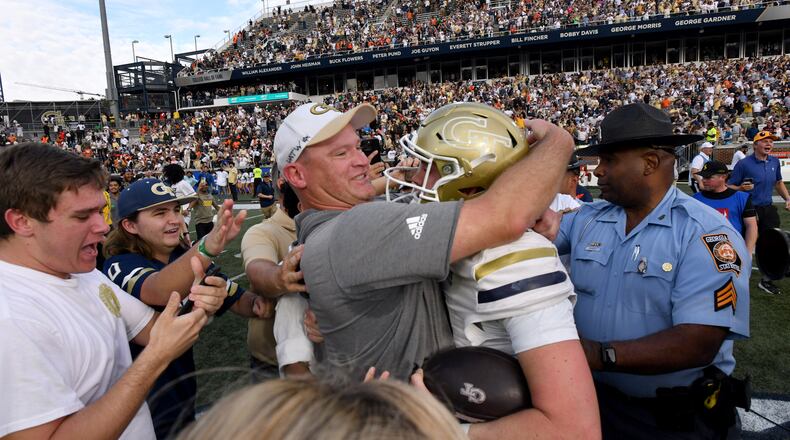Georgia Tech coach Brent Key and quarterback Haynes King (10) celebrate after defeating Miami in an NCAA college football game at Georgia Tech's Bobby Dodd Stadium, Saturday, November 9, 2024, in Atlanta. Georgia Tech won 28-23 over Miami. (Hyosub Shin / AJC)