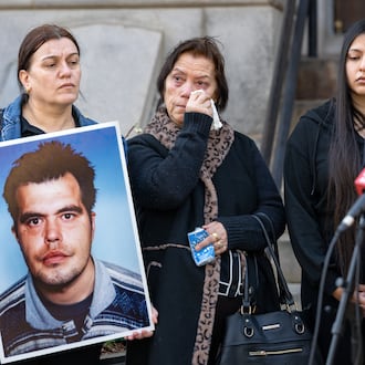 Arben Pilici's mother, Sebahate Pilici (center), wipes away tears at a press conference on Friday, Feb. 13, 2026 to announce a lawsuit against the DeKalb County Police Department in the death of her son. Arben's sister Drandofile Pilici holds a photo of him. They are joined by Arben's niece Lorita Jashari. (Ben Hendren for the AJC)