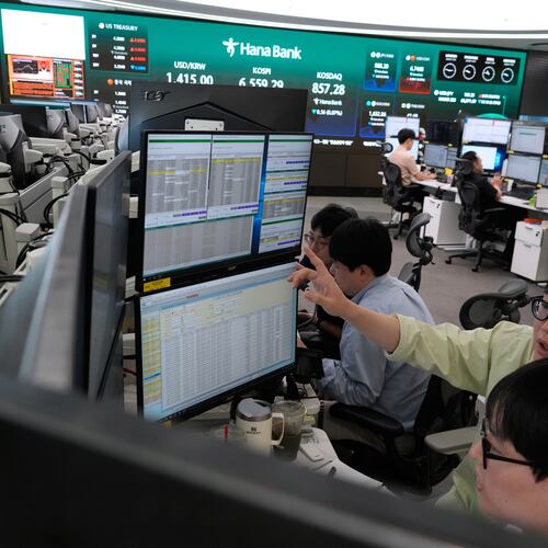 Currency traders work at the foreign exchange dealing room of the Hana Bank headquarters in Seoul, South Korea, Wednesday, Aug. 12, 2026. (AP Photo/Ahn Young-joon)