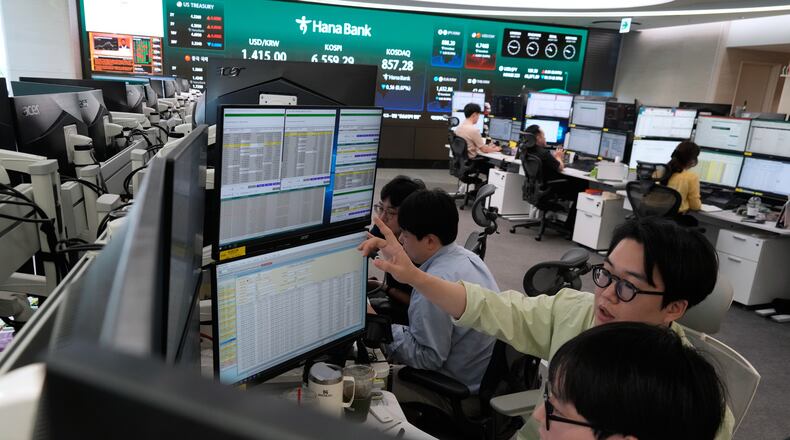 Currency traders work at the foreign exchange dealing room of the Hana Bank headquarters in Seoul, South Korea, Wednesday, Aug. 12, 2026. (AP Photo/Ahn Young-joon)