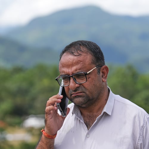 Rajendra Dawadi, a school teacher of Tribhuvan Trishuli Secondary School, talks on his mobile phone in Trishuli Valley in Nepal's Nuwakot district, Monday, Aug. 31, 2026. (AP Photo/Rajesh Kumar Singh)