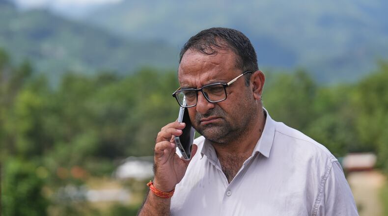 Rajendra Dawadi, a school teacher of Tribhuvan Trishuli Secondary School, talks on his mobile phone in Trishuli Valley in Nepal's Nuwakot district, Monday, Aug. 31, 2026. (AP Photo/Rajesh Kumar Singh)