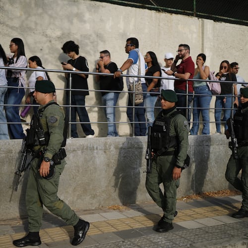 Soldiers patrol as voters arrive at a polling station during the presidential election in Barranquilla, Colombia, Sunday, May 31, 2026. (AP Photo/Ivan Valencia)