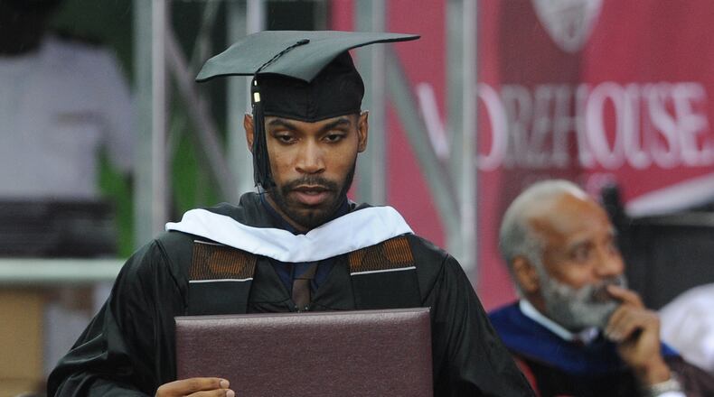 May 19, 2013 Atlanta: Genarlow Wilson holds his degree after graduating from Morehouse College on Sunday, May 19, 2013, in Atlanta, GA. Ten thousand guest and over 500 graduates sat in the rain during the event. President Barack Obam was the speaker for the event. JOHNNY CRAWFORD / JCRAWFORD@AJC.COM Genarlow Wilson, Morehouse Man (JOHNNY CRAWFORD / JCRAWFORD@AJC.COM)