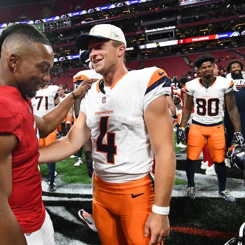 Falcons running back Bijan Robinson (left) and Broncos quarterback Sam Ehlinger greet each other after their preseason game at Mercedes-Benz Stadium on Friday, Aug. 14, 2026, in Atlanta. The Denver Broncos won, 27-7, over the Atlanta Falcons. (Hyosub Shin/AJC)
