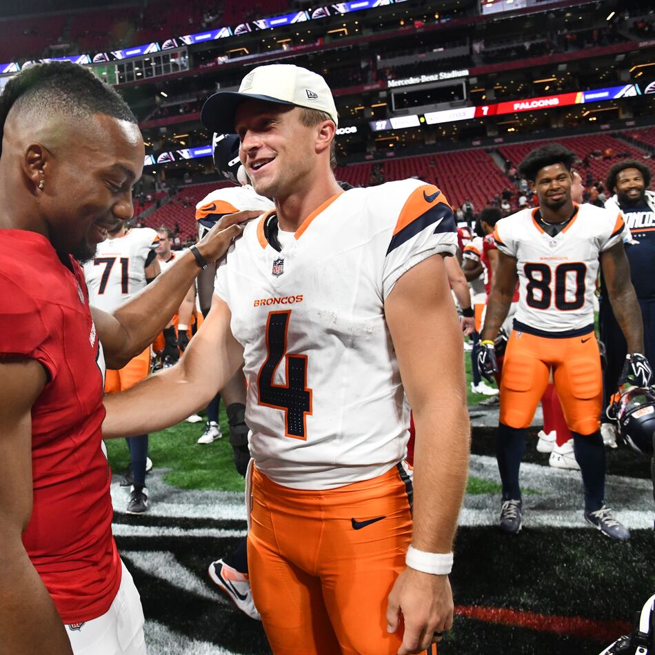 Falcons running back Bijan Robinson (left) and Broncos quarterback Sam Ehlinger greet each other after their preseason game at Mercedes-Benz Stadium on Friday, Aug. 14, 2026, in Atlanta. The Denver Broncos won, 27-7, over the Atlanta Falcons. (Hyosub Shin/AJC)