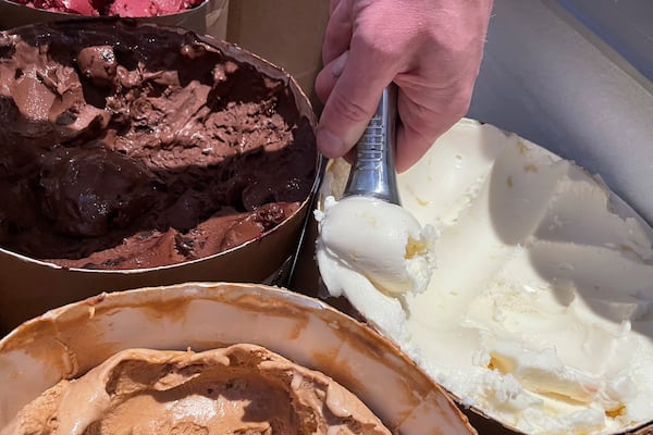 FILE - Salt & Straw Ice Cream Co-Founder Tyler Malek scoops "Day-Old Bread Pudding" upcycled ice cream in Los Gatos, Calif., on June 2, 2023. (AP Photo/Haven Daley, File)