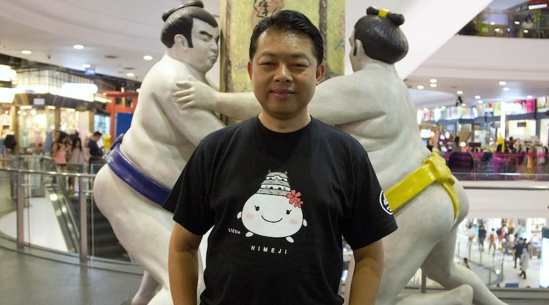 In this June 16, 2016 photo, Tanong Prakuptanon, who runs a Facebook site with 230,000 followers, “Japanthaifanclub,” which provides information and tips in Thai on tourism in Japan stands in a Japanese themed floor at a major shopping more in central Bangkok, Thailand. Thais admire Japanese craftsmanship and the culture’s emphasis on courteous and subdued manners, and tend to look to Japan as a role model. Thailand, meanwhile, is a favored destination for Japanese corporate investment and is seen an inviting tourist spot that’s different but not too foreign. The mutual affection between these two nations is rare in Asia, where historical, political and territorial tensions often complicate ties. (AP Photo/Mark Baker)