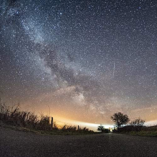 FILE - The milky way and traces of meteors illuminate the sky over Burg on the Baltic Sea island of Fehmarn, northern Germany, April 20, 2018. (Daniel Reinhardt/dpa via AP, File)