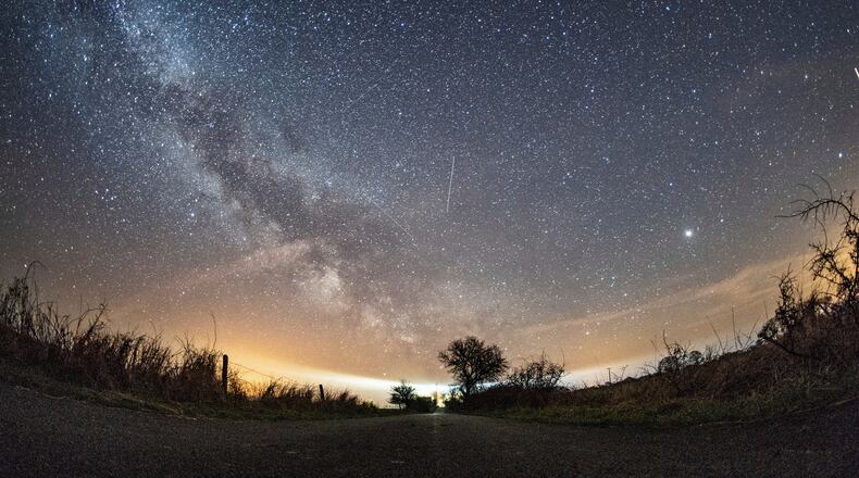 FILE - The milky way and traces of meteors illuminate the sky over Burg on the Baltic Sea island of Fehmarn, northern Germany, April 20, 2018. (Daniel Reinhardt/dpa via AP, File)