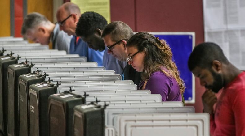 Atlanta: Voters pondered the ballots at Henry W. Grady High School in Atlanta on Tuesday May 22, 2018. JOHN SPINK/JSPINK@AJC.COM