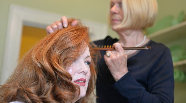Lorene Wright styles her daughter Pamela Wright's hair. HYOSUB SHIN / HSHIN@AJC.COM