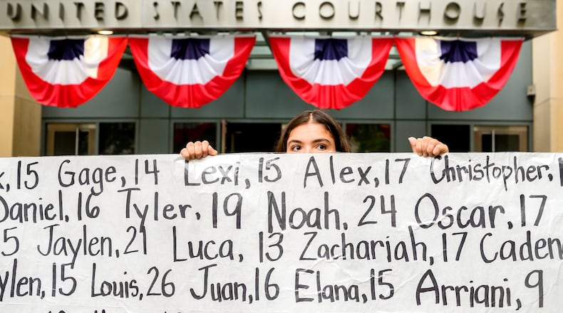 Olivia Konar holds a banner with names of young people who advocates say died as a result of social media outside the Ronald V. Dellums Federal Building and U.S. Courthouse on Tuesday, Aug. 18, 2026, in Oakland, Calif. Her sister Coco Konar died in 2022 when she was 17. (AP Photo/Noah Berger)