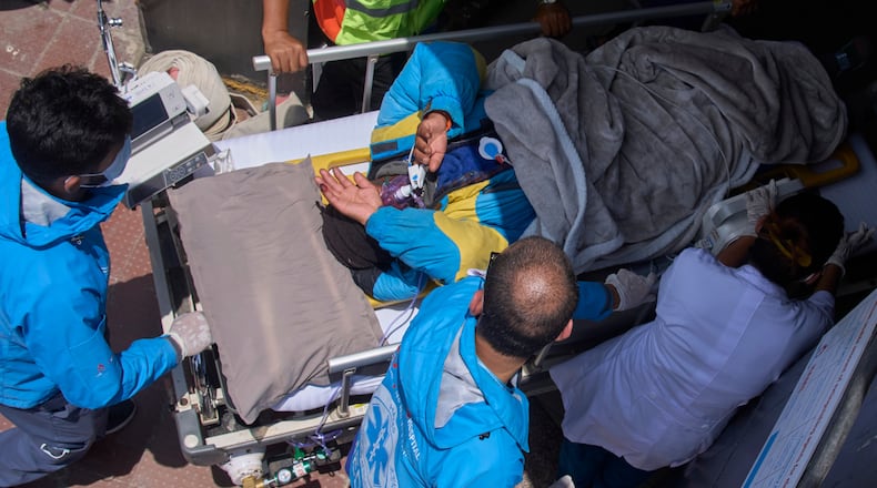 Medics take Dawa Sherpa, a mountain guide who had been missing for several days in the Everest region, for treatment after he arrived at HAMS Hospital in Kathmandu, Nepal, Thursday, June 4, 2026. (AP Photo/Niranjan Shrestha) CORRECTION: Corrects hospital name to HAMS not Grande