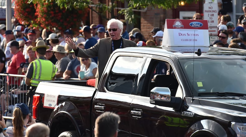 Don Sutton, a 1998 inductee into the National Baseball Hall of Fame, waves to spectators from the back of a pickup truck during the "Legends Parade" in Cooperstown, N.Y., in July 2018.