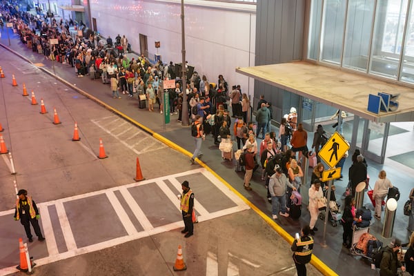 Lines for domestic security spill out of the north terminal onto the sidewalk at Hartsfield-Jackson on Thursday. (Ben Hendren for the AJC)