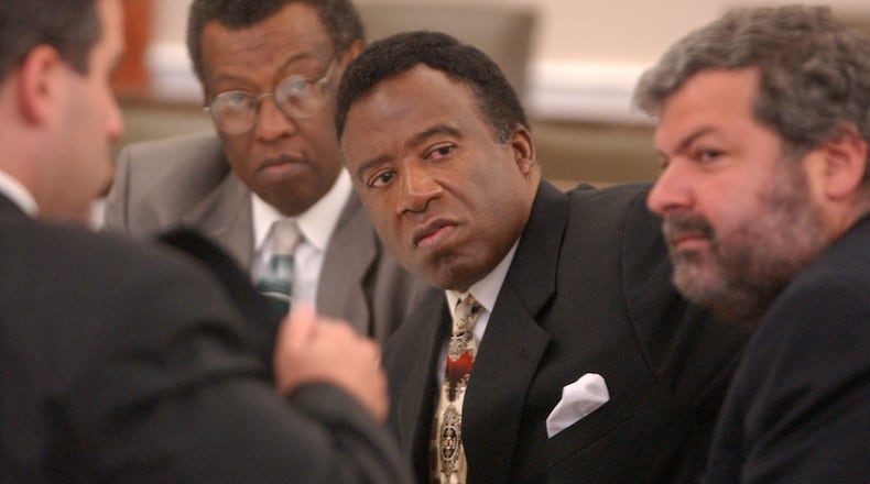 Former DeKalb County Sheriff Sidney Dorsey (center) speaks with his defense team during his 2002 trial in Albany. Dorsey, who was convicted in the murder of his political rival, Derwin Brown, died of natural causes at Augusta State Medical Prison this week. (AJC 2002)
