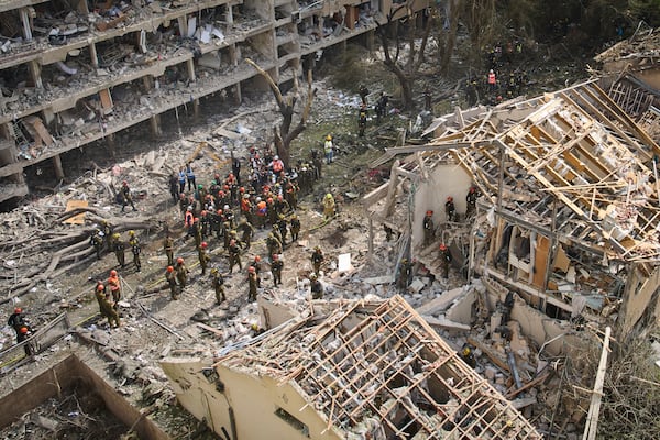 Firefighters, rescue workers and military work at the site of a direct missile strike launched from Iran in Tel Aviv, Israel, on Sunday, June 22, 2025. (AP Photo/Oded Balilty)