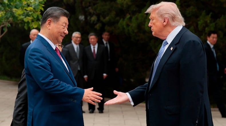 FILE - U.S. President Donald Trump, right, shakes hands with Chinese President Xi Jinping while leaving after a visit to the Zhongnanhai Garden in Beijing, Friday, May 15, 2026. (Evan Vucci/Pool Photo via AP, file)