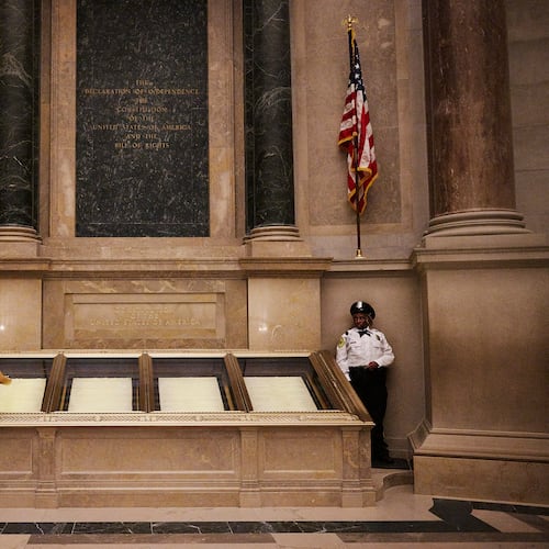 The Declaration of Independence is displayed at the National Archives under dim lights to slow the degradation of the ink. (Jared Soares/The New York Times)