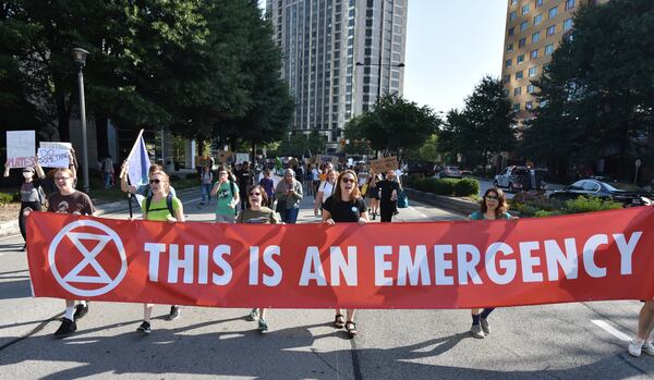 Protesters march on Peachtree Road near Buckhead MARTA transit station during Southeast Climate Strike and Rebellion on Friday, September 27, 2019. 