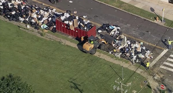 Trash is cleaned up at a drop-off site in Philadelphia as thousands of city workers remained on strike Tuesday, July 8, 2025. (WPVI-TV via AP)