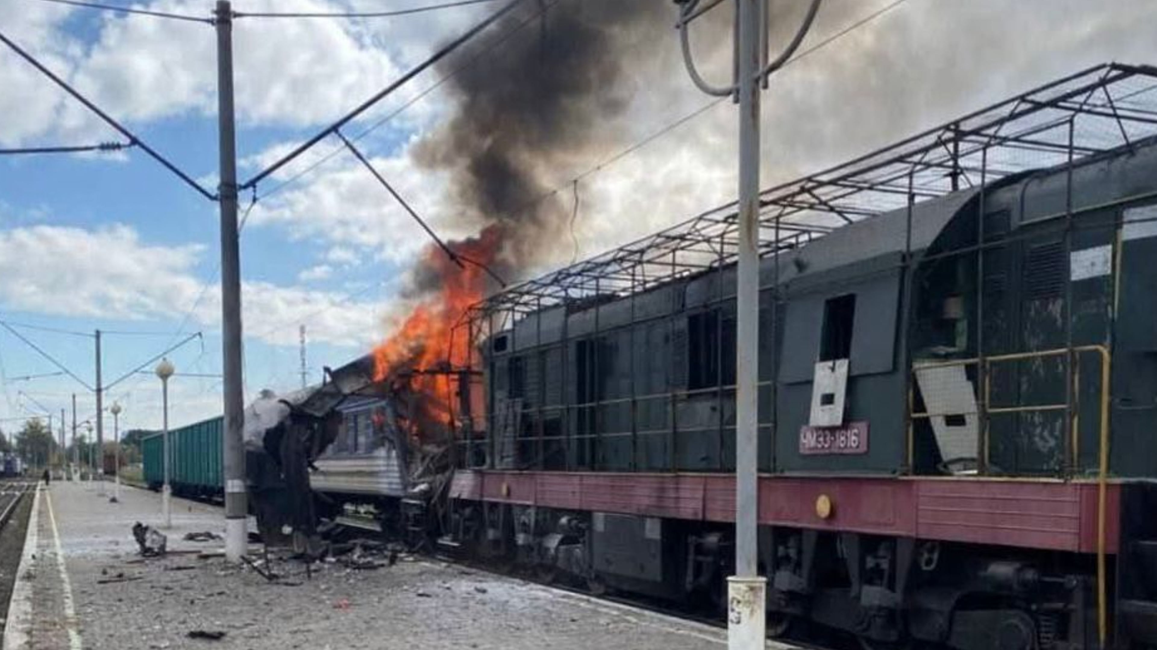 In this photo provided by the Ukrainian Railway press office, a passenger train is engulfed in flames following Russia's drone attack on a railway station in Shostka, Sumy region, Ukraine, Saturday, Oct. 4, 2025. (Ukrainian Railway via AP)