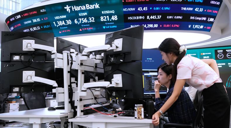 Currency traders watch monitors at the foreign exchange dealing room of the Hana Bank headquarters in Seoul, South Korea, Wednesday, Aug. 26, 2026. (AP Photo/Ahn Young-joon)