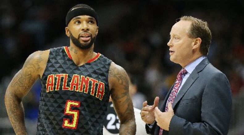 Hawks guard Malcolm Delaney and coach Mike Budenholzer. (Curtis Compton/ccompton@ajc.com)